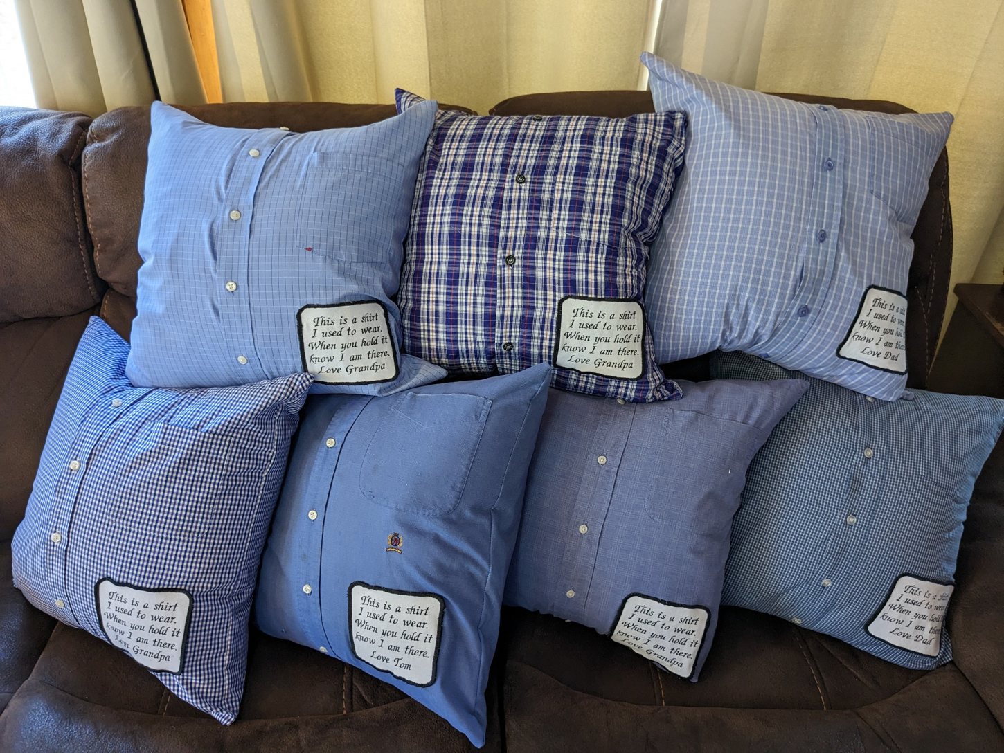 A collection of handmade memory pillows sewn from cherished shirts